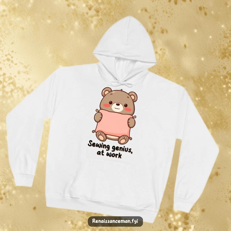 Funny hoodie design: a smiling bear proudly holds up a beautifully sewn cushion, radiating warmth and crafting accomplishment.